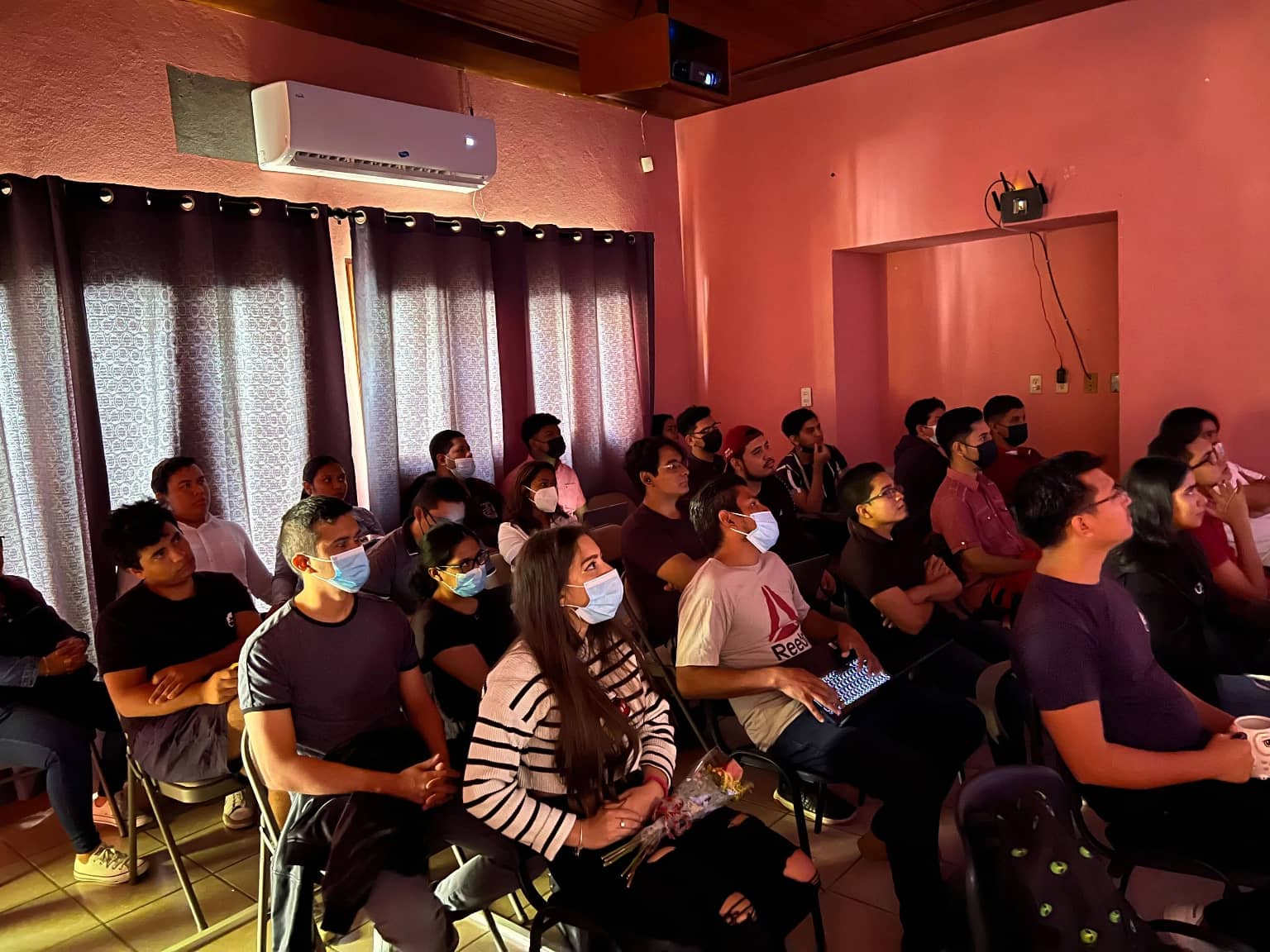 Attendees of our Nerdify Devs Talks, completely focused on the speaker's presentation